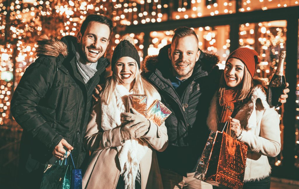 family and friends smiling while shopping during the holiday season