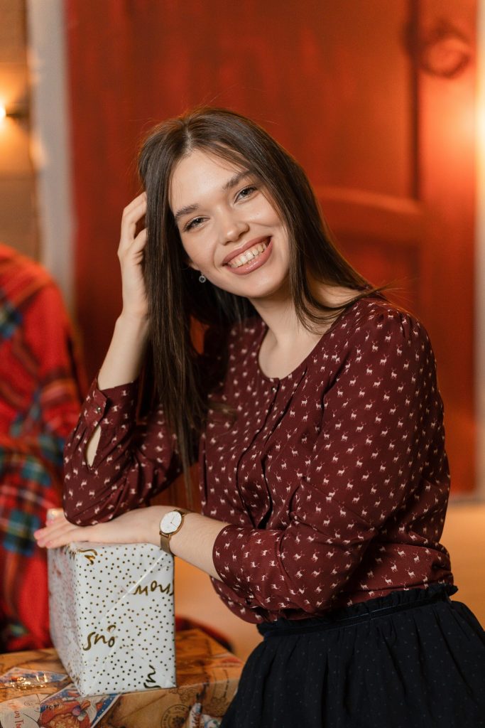 women smiling holding a present