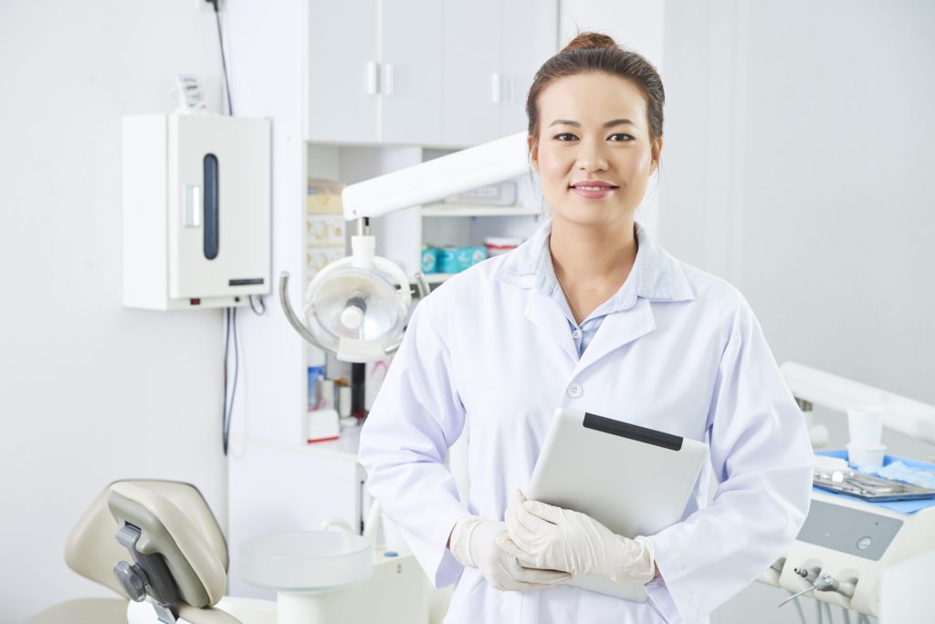 dentist holding tablet in office