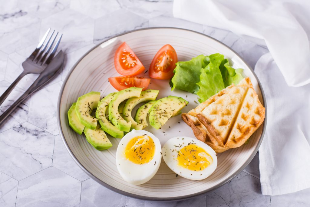 close up of avocado and soft boiled egg