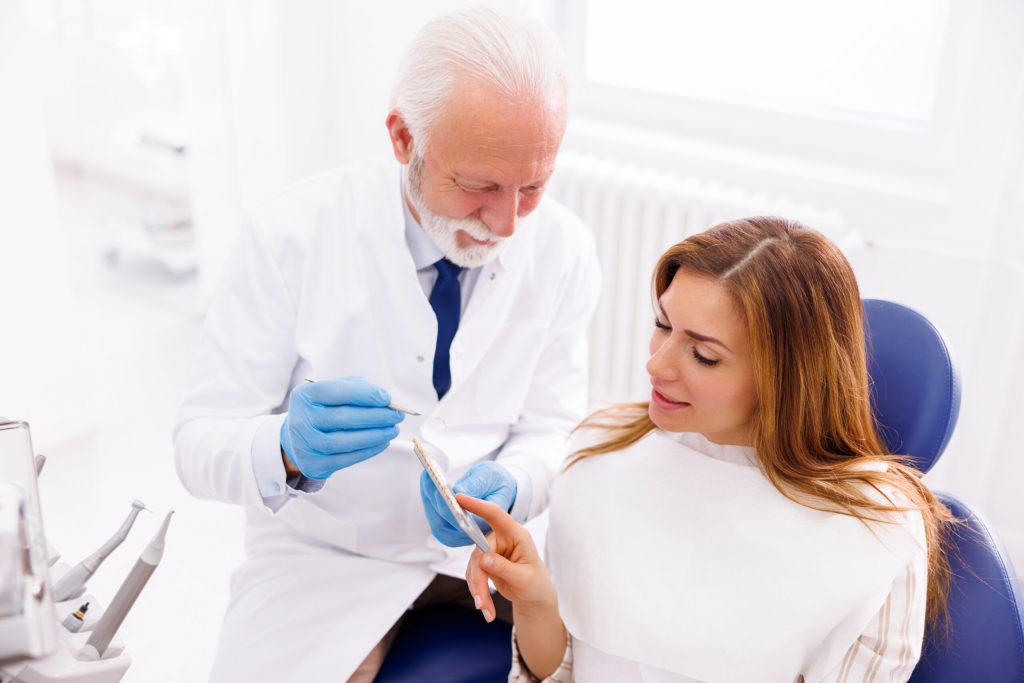 dentist showing dental model to patient