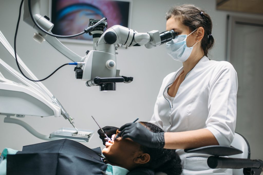 dentist cleaning teeth with machine