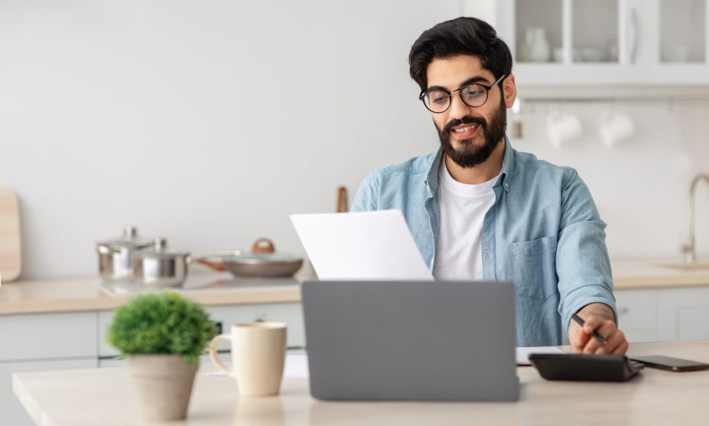 man doing insurance research on his laptop